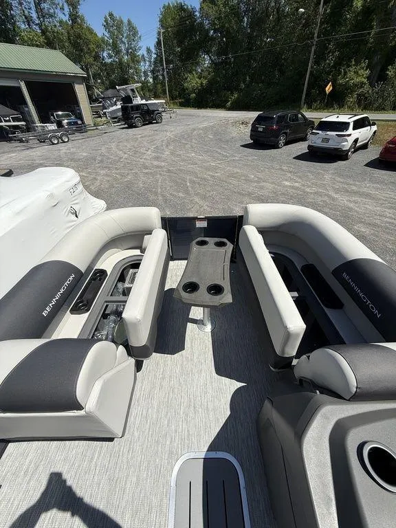 Slide: The Image of 2026 Bennington S Quad Bench 22 SSR pontoon boat interior with seating and cup holders. - 23