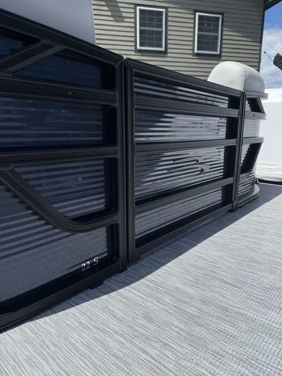 Slide: The Image of 2026 Bennington S Quad Bench 22 SSR pontoon boat, sleek design, outdoor setting. - 4