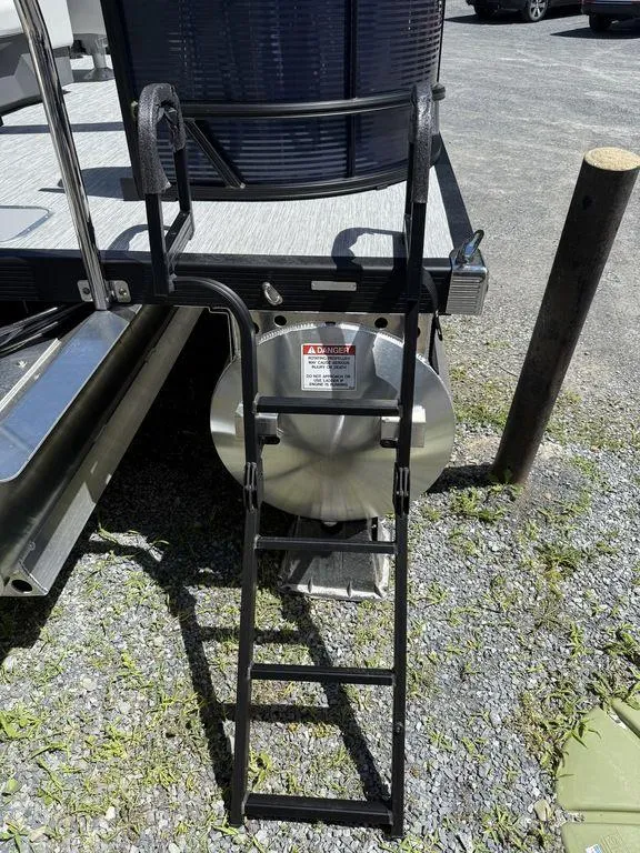 Slide: The Image of Rear view of 2026 Bennington S Quad Bench 22 SSR with ladder and warning label. - 6