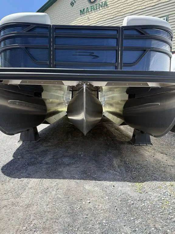 Slide: The Image of 2026 Bennington S Quad Bench 22 SSR pontoon boat at marina, viewed from below. - 7