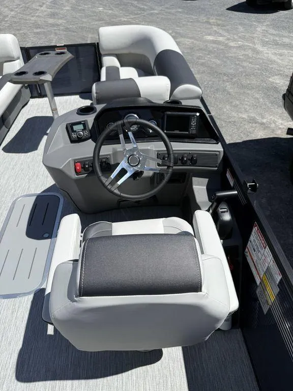 Slide: The Image of 2026 Bennington S Quad Bench 22 SSR boat interior with steering wheel and seating. - 8