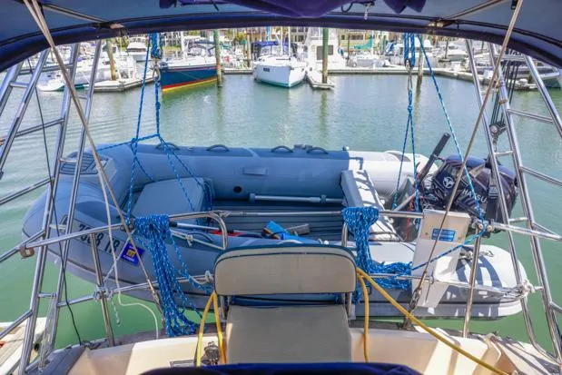 Slide: The Image of Sailboat Island Packet 40, 1998 model, with dinghy at marina dock. - 13