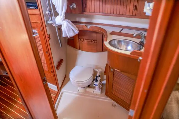 Slide: The Image of 1998 Island Packet 40 yacht bathroom with wooden cabinetry and compact design. - 17