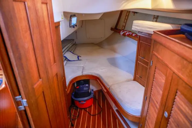 Slide: The Image of 1998 Island Packet 40 interior cabin with wooden finish and cozy sleeping area. - 19