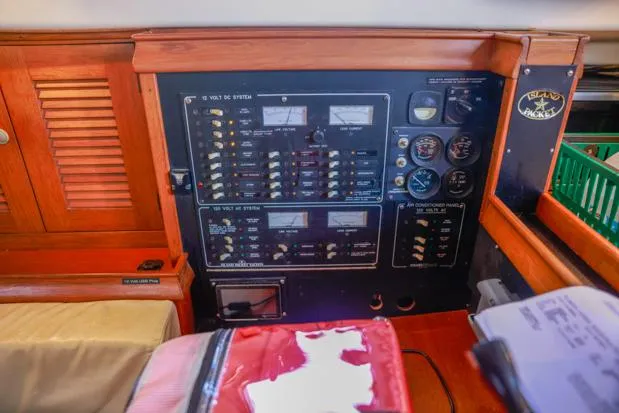Slide: The Image of Electrical control panel on a 1998 Island Packet 40 sailboat, featuring gauges and switches. - 20
