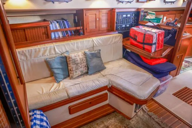 Slide: The Image of Cozy interior of 1998 Island Packet 40 yacht with cushioned seating and nautical decor. - 21