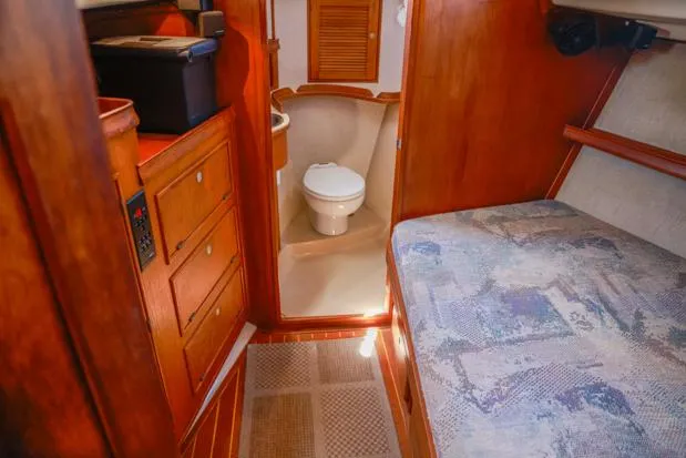 Slide: The Image of Interior of 1998 Island Packet 40 sailboat with wooden cabinetry and compact bathroom. - 24