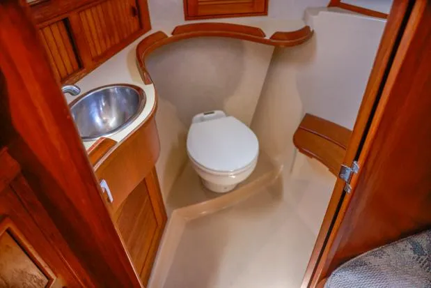 Slide: The Image of 1998 Island Packet 40 yacht bathroom with wooden cabinetry and compact design. - 25