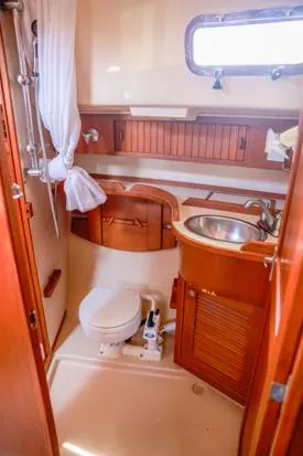 Slide: The Image of 1998 Island Packet 40 yacht bathroom with wooden cabinetry and compact design. - 28