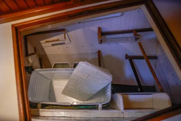 Slide: The Image of Interior view of a 1998 Island Packet 40 sailboat, showing storage compartments and a bin. - 29
