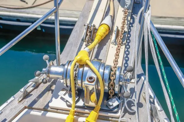 Slide: The Image of Bow of 1998 Island Packet 40 sailboat with anchor chain and yellow power cables. - 31