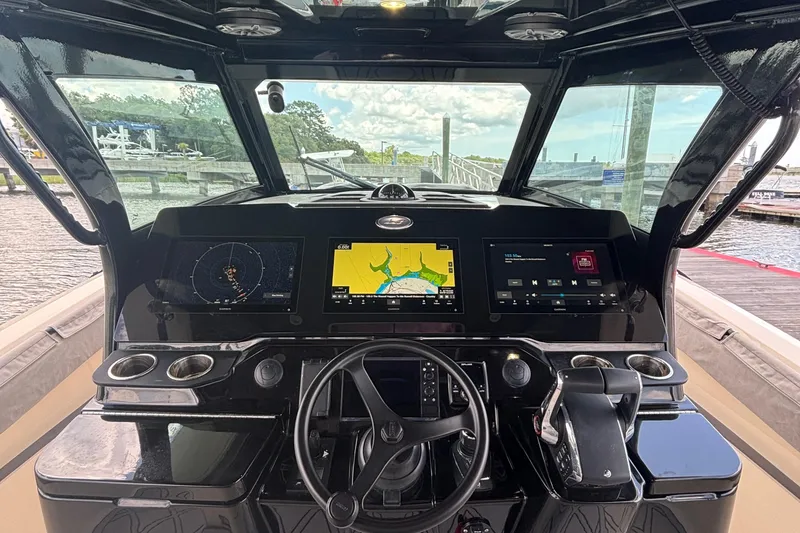Slide: The Image of 2024 Scout 377 LXF boat dashboard with navigation screens and controls. - 10