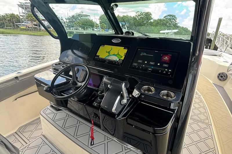 Slide: The Image of 2024 Scout 377 LXF boat dashboard with navigation and control systems. - 11