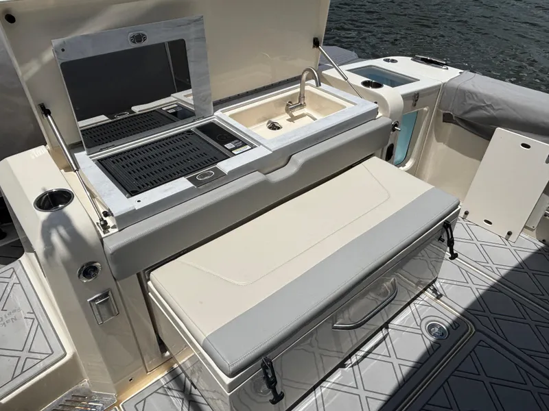 Slide: The Image of 2024 Scout 377 LXF boat with outdoor kitchen and seating area. - 19