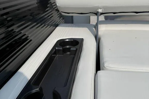 Slide: The Image of 2026 Bennington S Swingback 22 SSB interior with cup holders and white seating. - 12