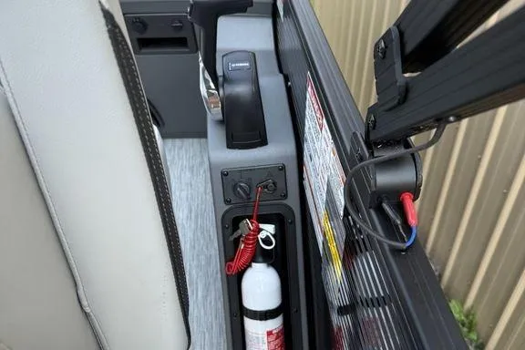 Slide: The Image of 2026 Bennington S Swingback 22 SSB boat interior with control panel and fire extinguisher. - 17