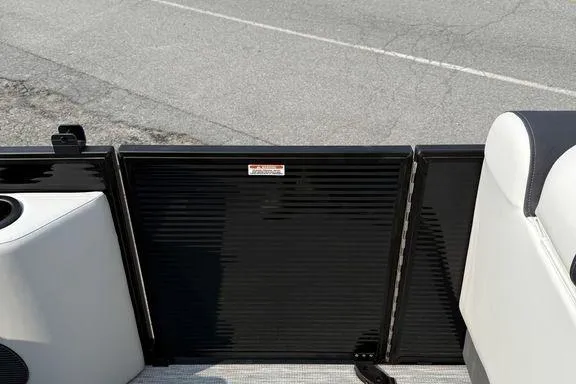 Slide: The Image of 2026 Bennington S Swingback 22 SSB boat interior with black panel and seating. - 19