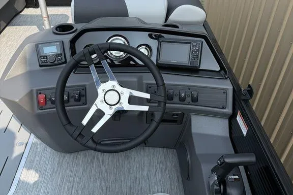 Slide: The Image of 2026 Bennington S Swingback 22 SSB dashboard with steering wheel and controls. - 23