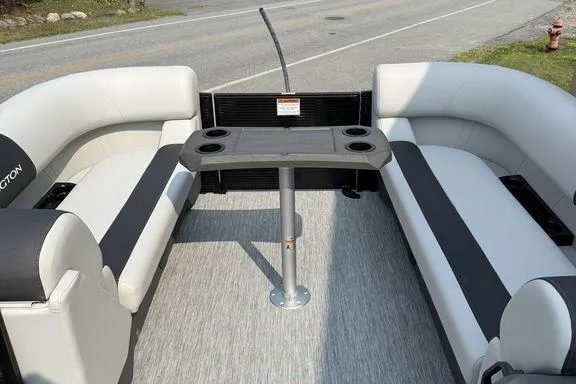 Slide: The Image of 2026 Bennington S Swingback 22 SSB interior with seating and table on a road. - 24