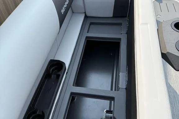 Slide: The Image of 2026 Bennington S Swingback 22 SSB boat interior with storage compartments and cup holders. - 29