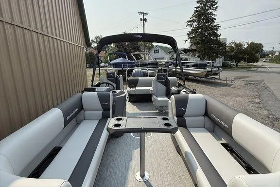 Slide: The Image of 2026 Bennington S Swingback 22 SSB pontoon boat with spacious seating and table setup. - 31