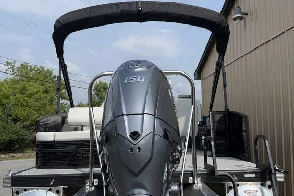 Slide: The Image of 2026 Bennington S Swingback 22 SSB pontoon boat with 150 HP engine, docked outdoors. - 7