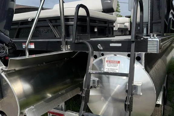 Slide: The Image of 2026 Bennington S Swingback 22 SSB pontoon boat, rear view with ladder and safety warning. - 8