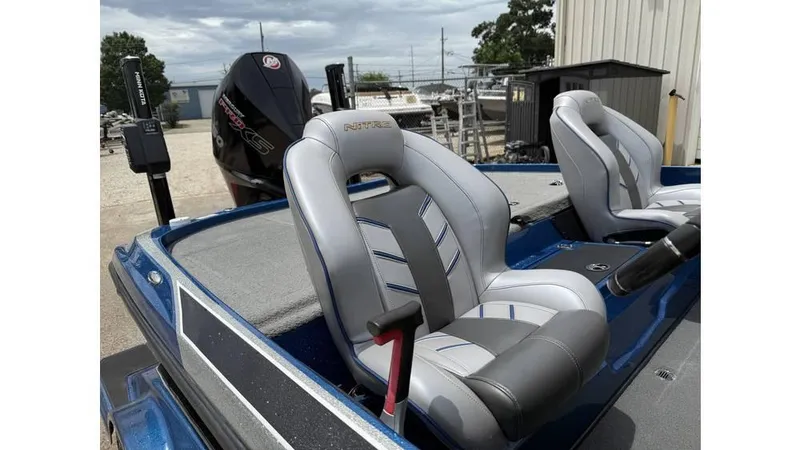 Slide: The Image of 2019 Nitro Z20 boat with sleek seating and powerful engine, parked outdoors. - 10