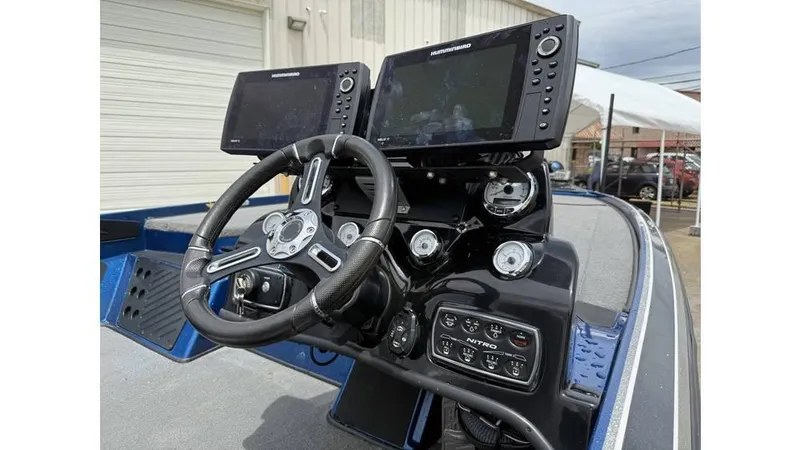 Slide: The Image of Dashboard of a 2019 Nitro Z20 boat with dual fish finders and steering wheel. - 11