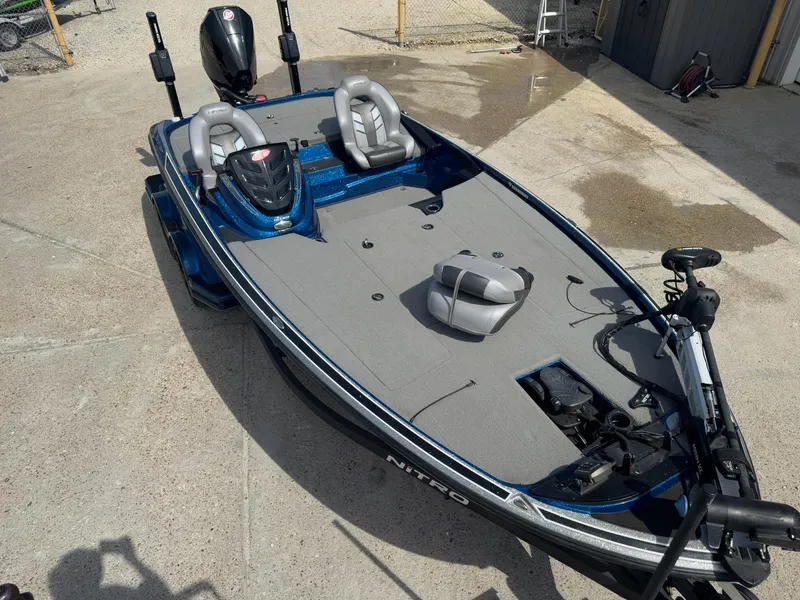 Slide: The Image of 2019 Nitro Z20 fishing boat with dual seats and motor, parked on concrete. - 12