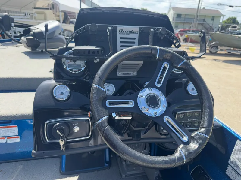Slide: The Image of Steering wheel and dashboard of a 2019 Nitro Z20 boat, featuring gauges and controls. - 16