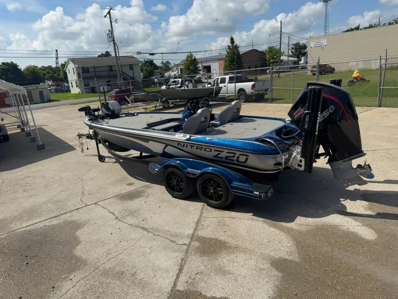 Slide: The Image of 2019 Nitro Z20 boat with trailer, parked outdoors on a sunny day. - 2
