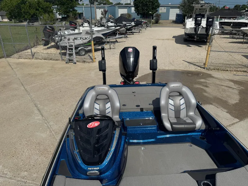 Slide: The Image of 2019 Nitro Z20 boat with dual seats, parked in a marina with other watercraft. - 30