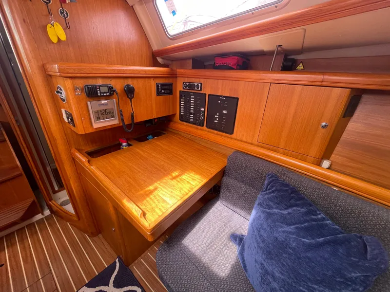 Slide: The Image of Interior of a 2004 Hunter 36 sailboat with navigation station and seating area. - 13