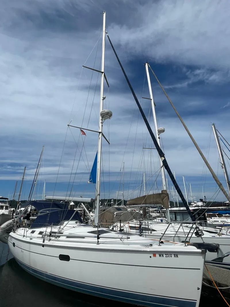Slide: The Image of 2004 Hunter 36 sailboat docked at marina under cloudy sky. - 19