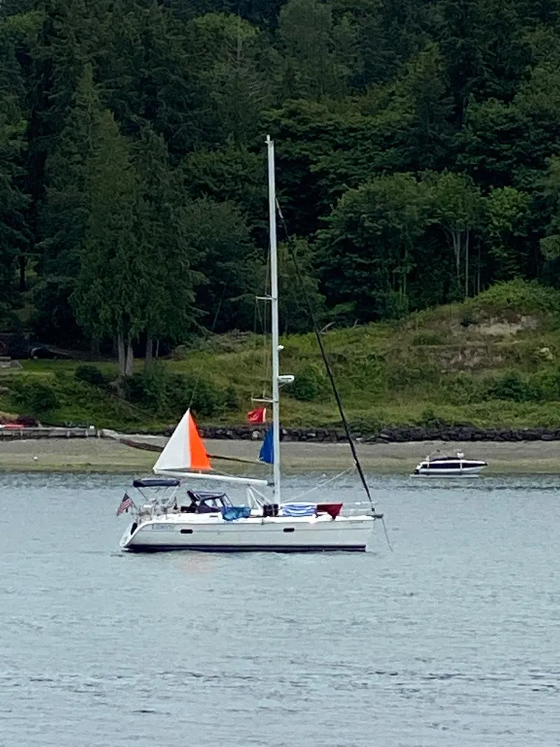 Slide: The Image of Sailboat Hunter 36 (2004) on calm water near a forested shoreline. - 20