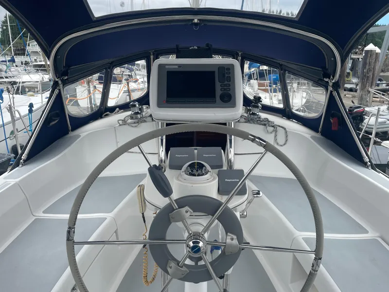 Slide: The Image of Steering wheel and navigation equipment on a 2004 Hunter 36 sailboat cockpit. - 4