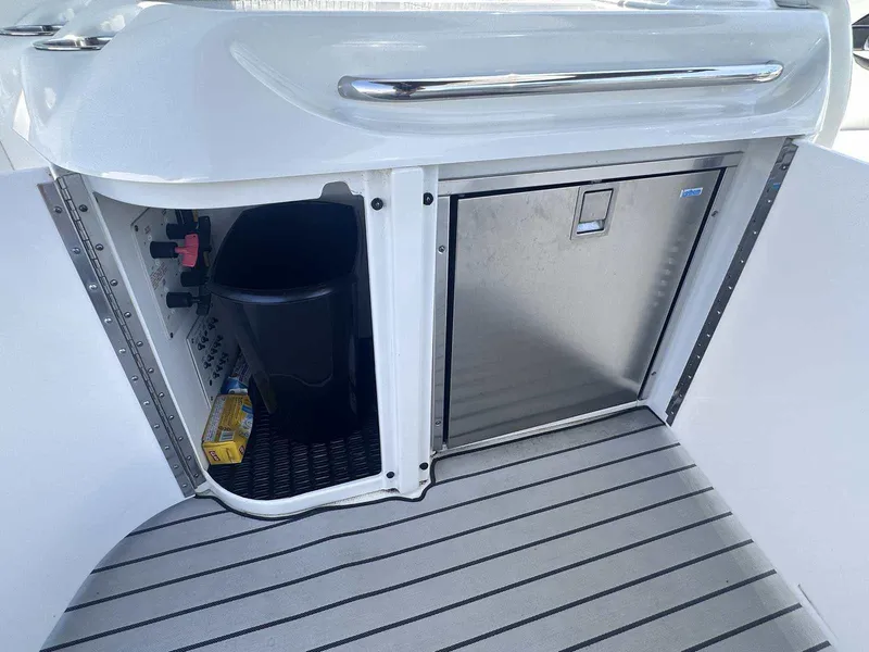 Slide: The Image of 2007 Formula 310 Sun Sport boat interior with storage and stainless steel compartment. - 11