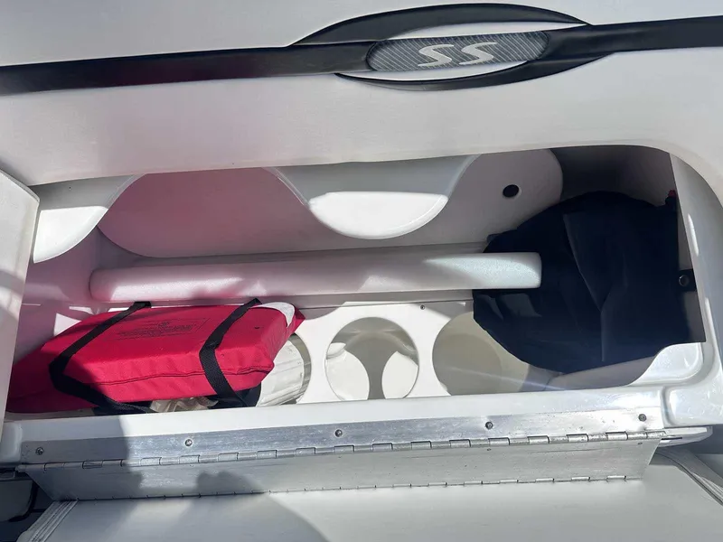 Slide: The Image of Storage compartment in a 2007 Formula 310 Sun Sport boat with red life jacket. - 13