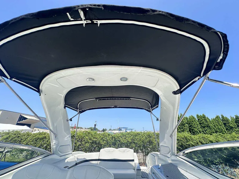 Slide: The Image of 2007 Formula 310 Sun Sport boat with black canopy under clear blue sky. - 14