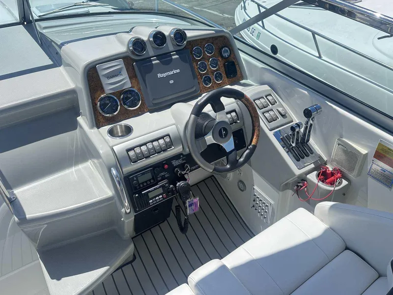 Slide: The Image of 2007 Formula 310 Sun Sport boat cockpit with steering wheel and navigation controls. - 17