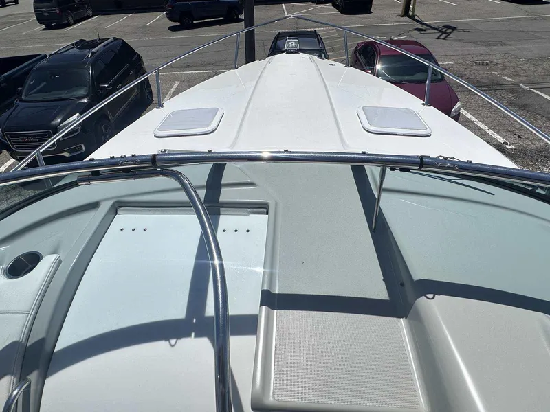 Slide: The Image of 2007 Formula 310 Sun Sport boat deck in a parking lot, surrounded by cars. - 21