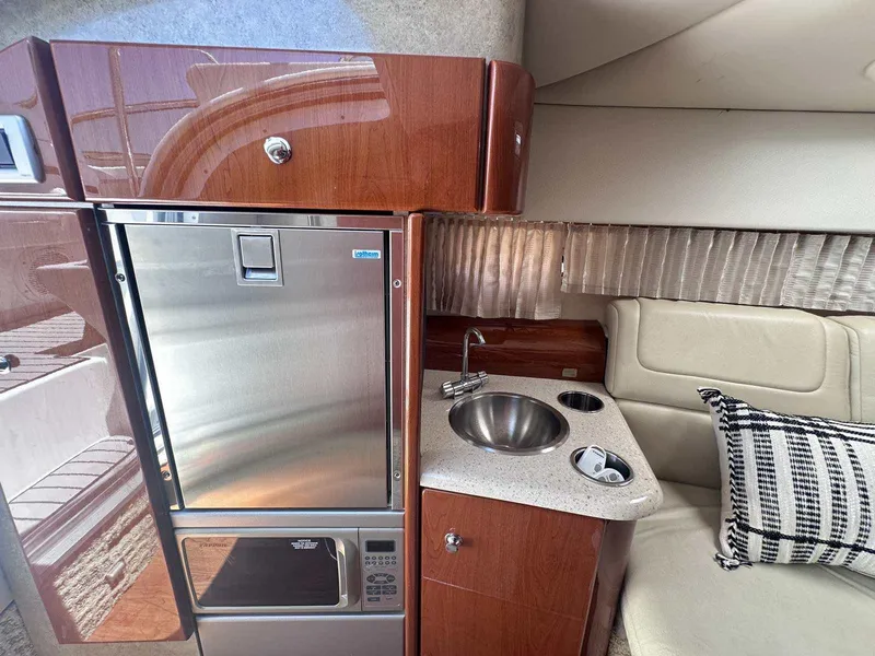 Slide: The Image of Interior of 2007 Formula 310 Sun Sport with kitchenette, sink, and seating area. - 25