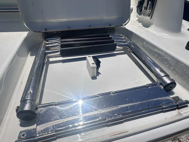 Slide: The Image of 2007 Formula 310 Sun Sport boat ladder in open storage compartment, reflecting sunlight. - 4