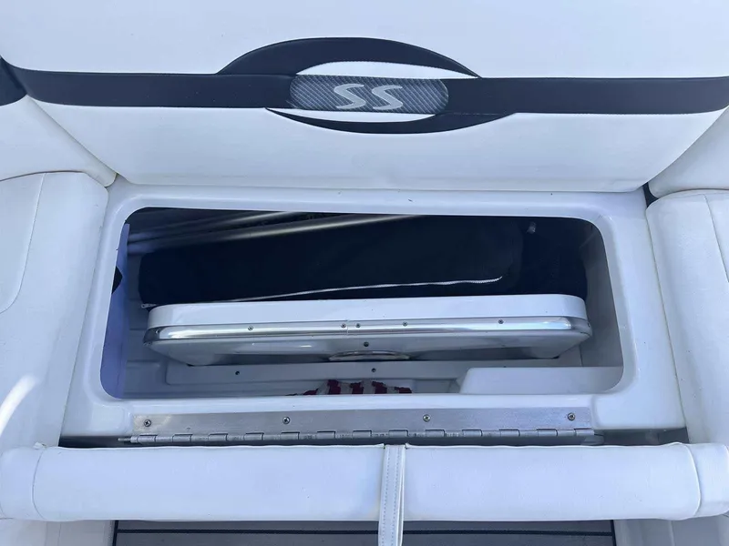 Slide: The Image of Storage compartment on a 2007 Formula 310 Sun Sport boat, featuring sleek white upholstery. - 8