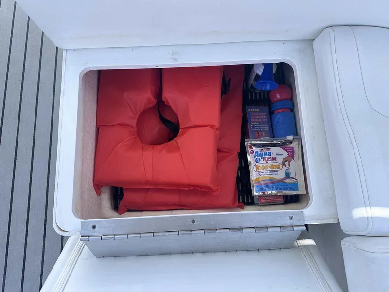 Slide: The Image of Storage compartment in a 2007 Formula 310 Sun Sport with life jackets and boating supplies. - 9