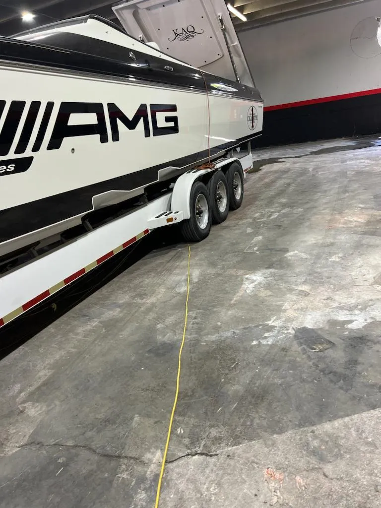 Slide: The Image of 2012 Cigarette 50' Marauder AMG boat on trailer in garage. - 2