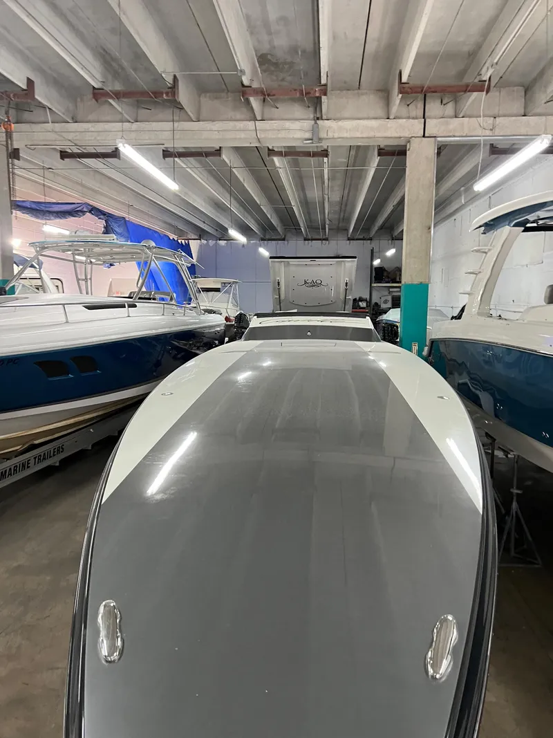 Slide: The Image of 2012 Cigarette 50' Marauder AMG boat in storage, surrounded by other vessels. - 3