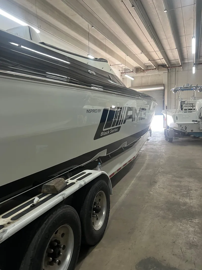 Slide: The Image of 2012 Cigarette 50' Marauder AMG boat in a garage, side view. - 5