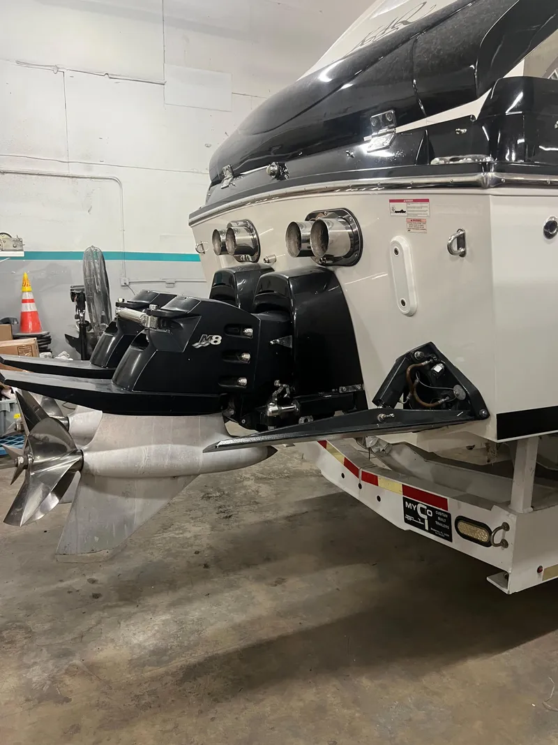 Slide: The Image of 2012 Cigarette 50' Marauder AMG boat stern with powerful outboard motor in a garage. - 6